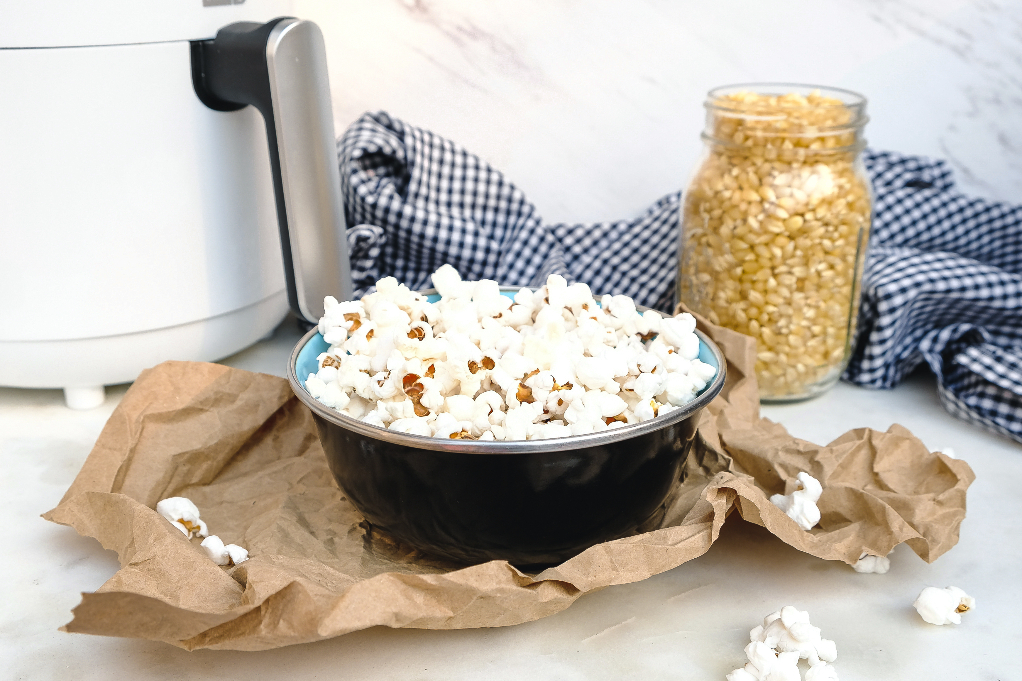 Popcorn fresh popped in an air fryer ready to enjoy.