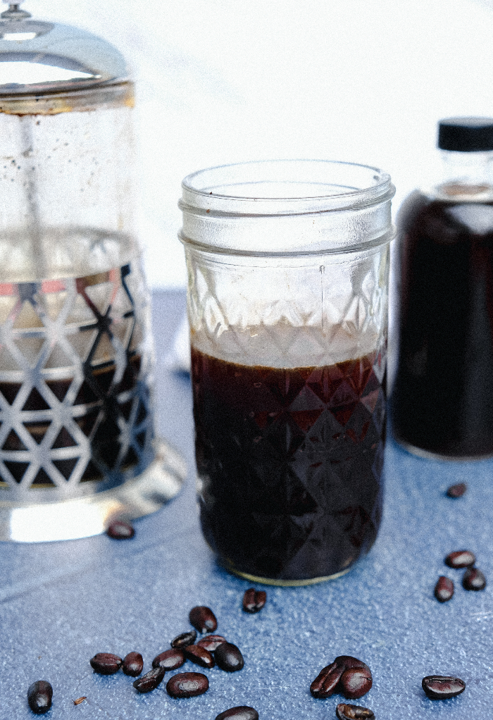 Strong coffee in a glass mason jar.