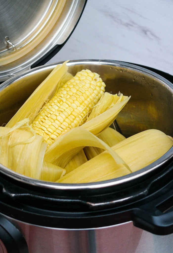 Cooked corn on the cob in a pressure cooker.