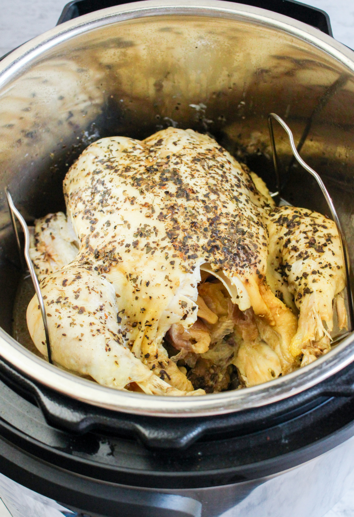 Cooked whole chicken ready to remove from an Instant Pot.