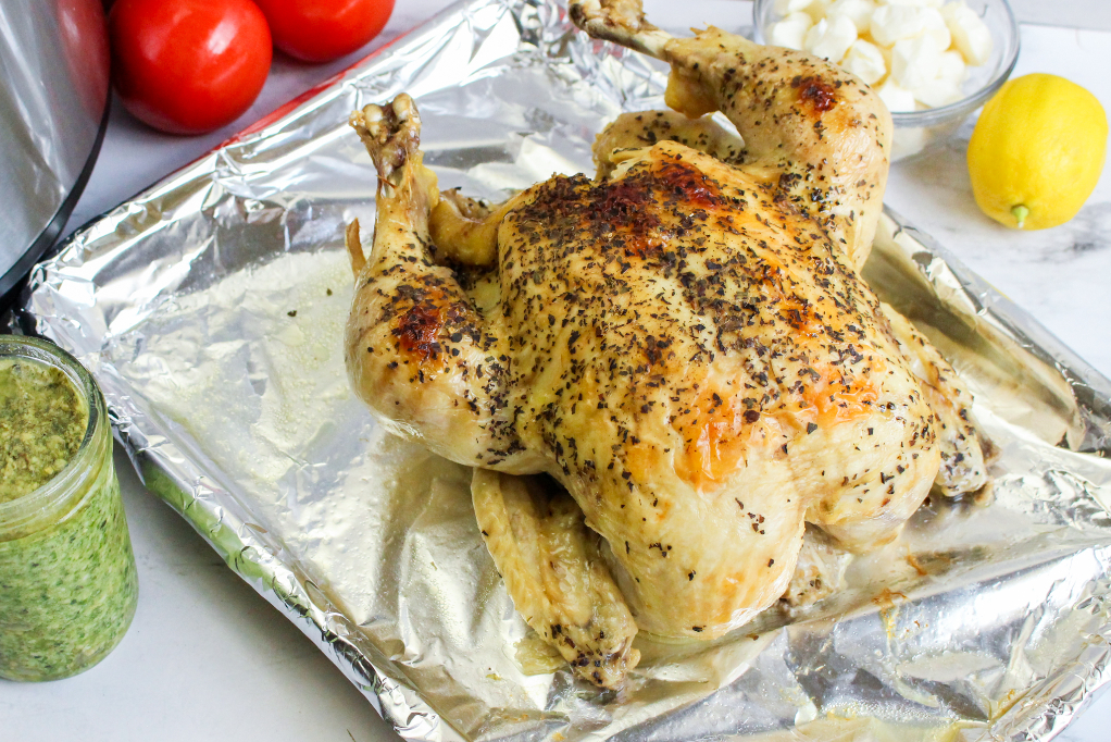 Chicken on a baking sheet covered with foil.