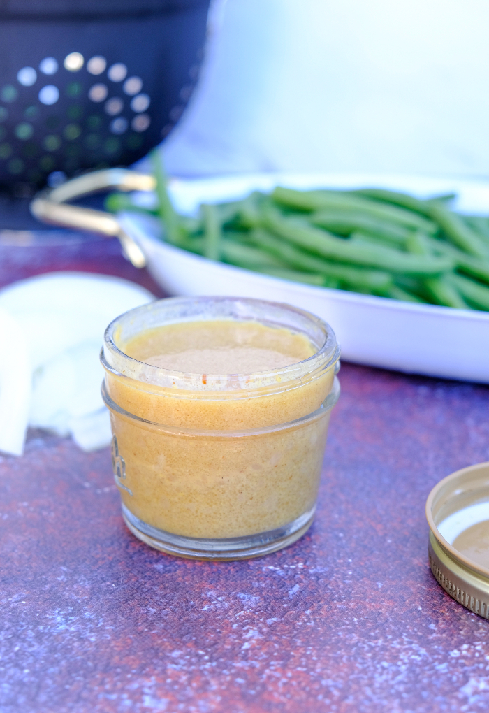 Homemade mustard vinaigrette in a small mason jar. 