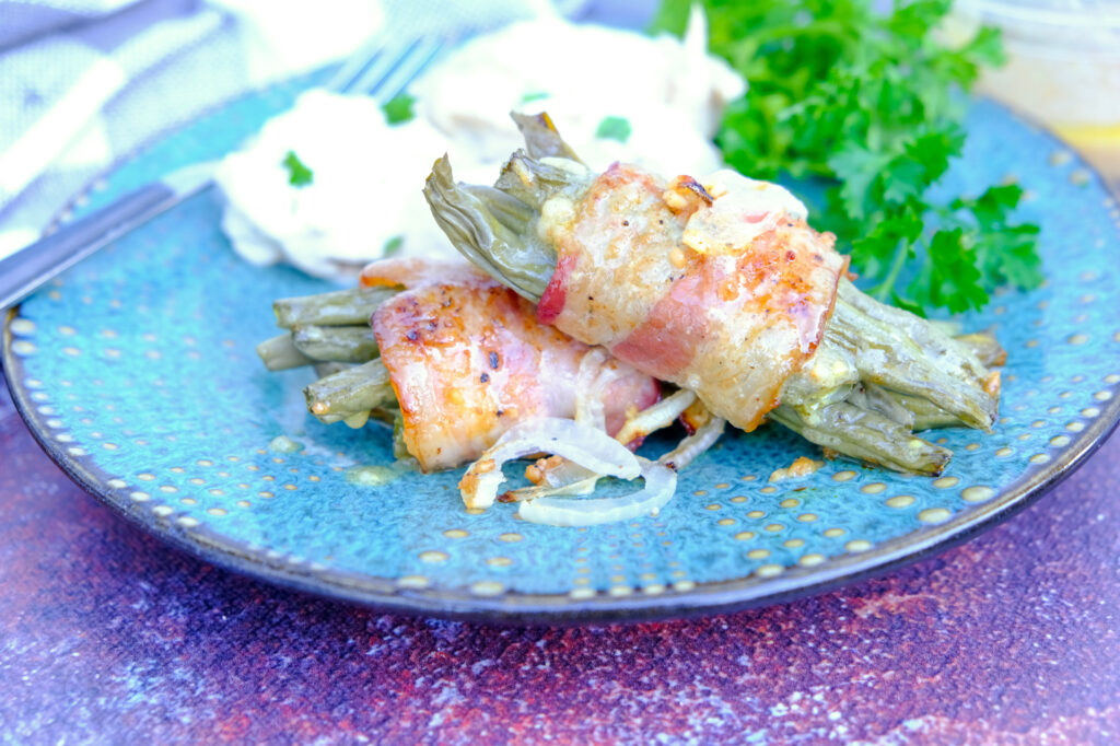 Green bean bundles on a teal plate ready to enjoy.