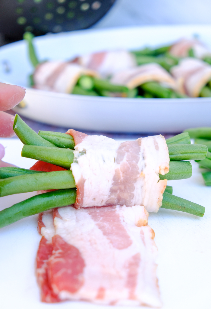 Bacon wrapped over fresh green beans.