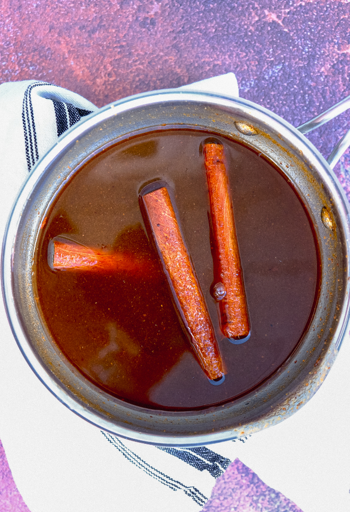 Pumpkin spice syrup in a small saucepan simmering. 