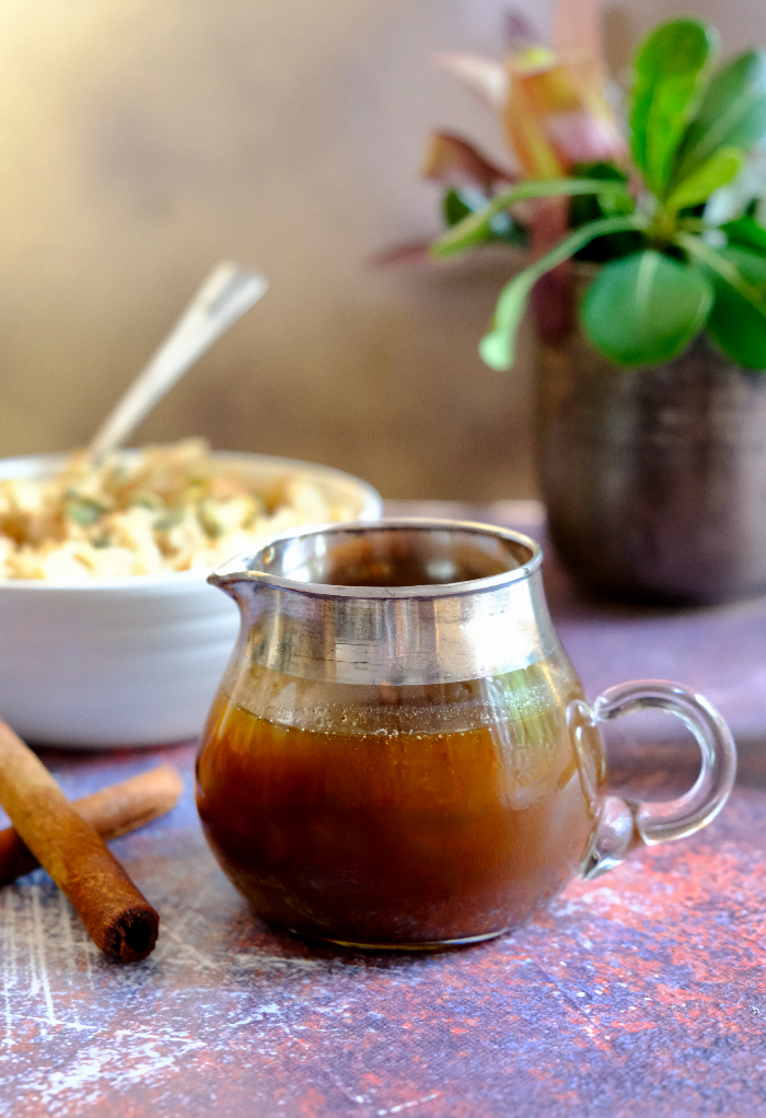 Pumpkin spice syrup in a small glass pitcher.