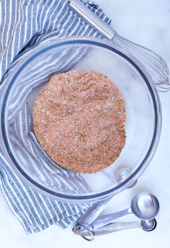 Pork rub spices in a clearing mixing bowl.