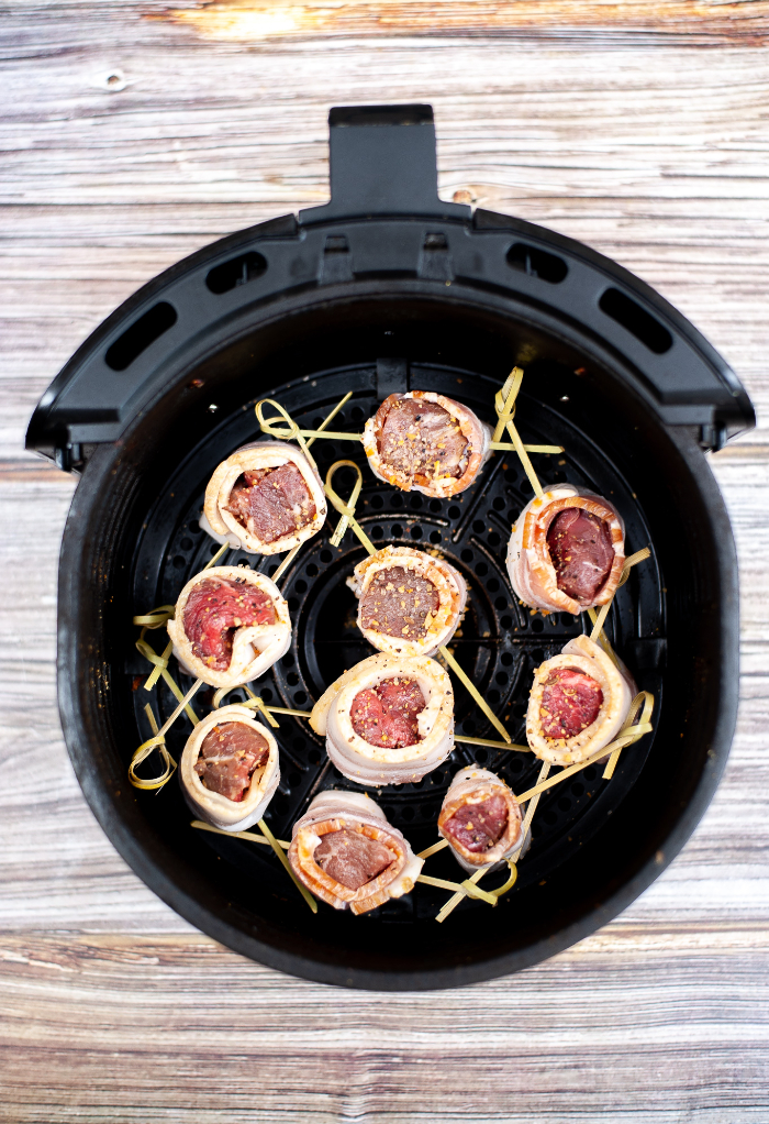 Air Fryer Steak Bites ready to fry in a black fryer.