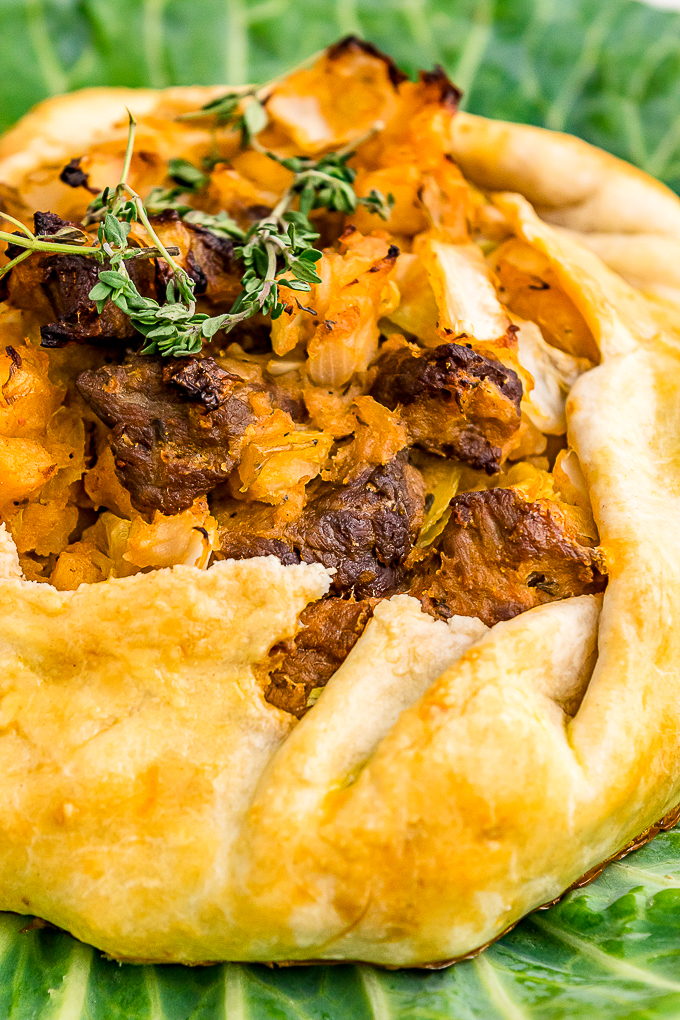 A close view of a savory galette on lettuce leaves. 