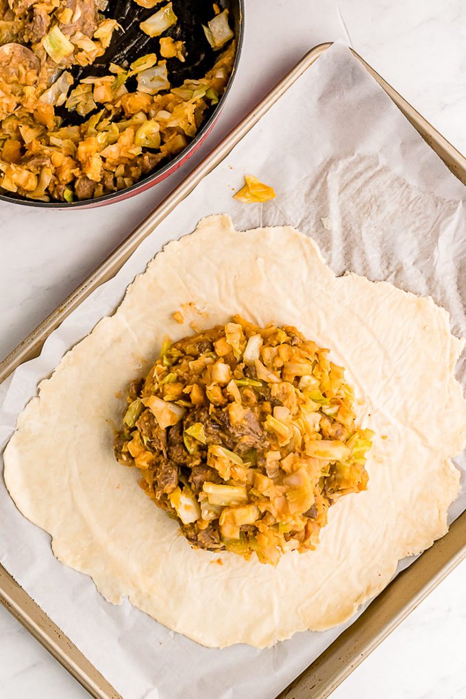 Pastry with meat and potato ready to bake.