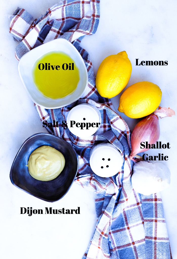 Overhead view of ingredients for dijon lemon vinaigrette. 