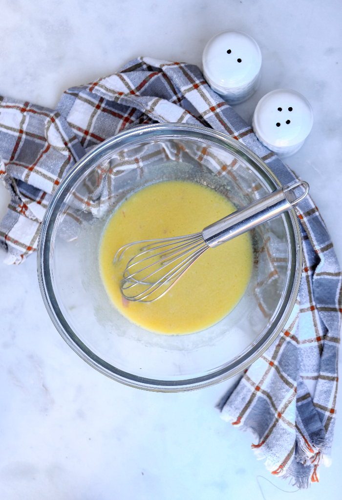 Homemade dijon lemon vinaigrette in a clear bowl.