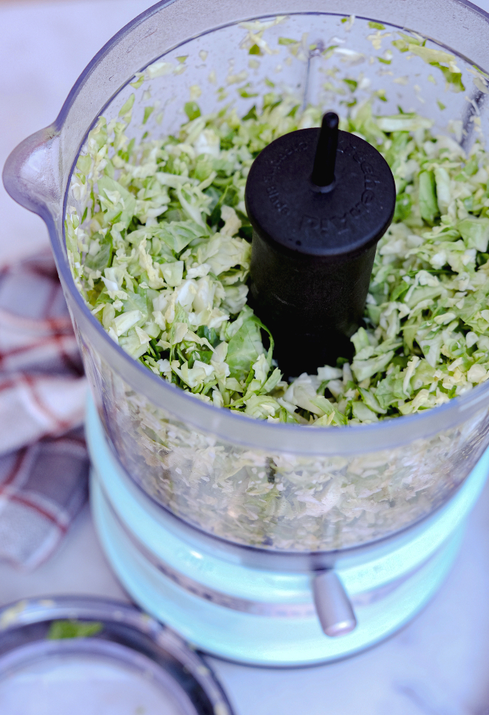 Shaved Brussel sprouts in a food processor.