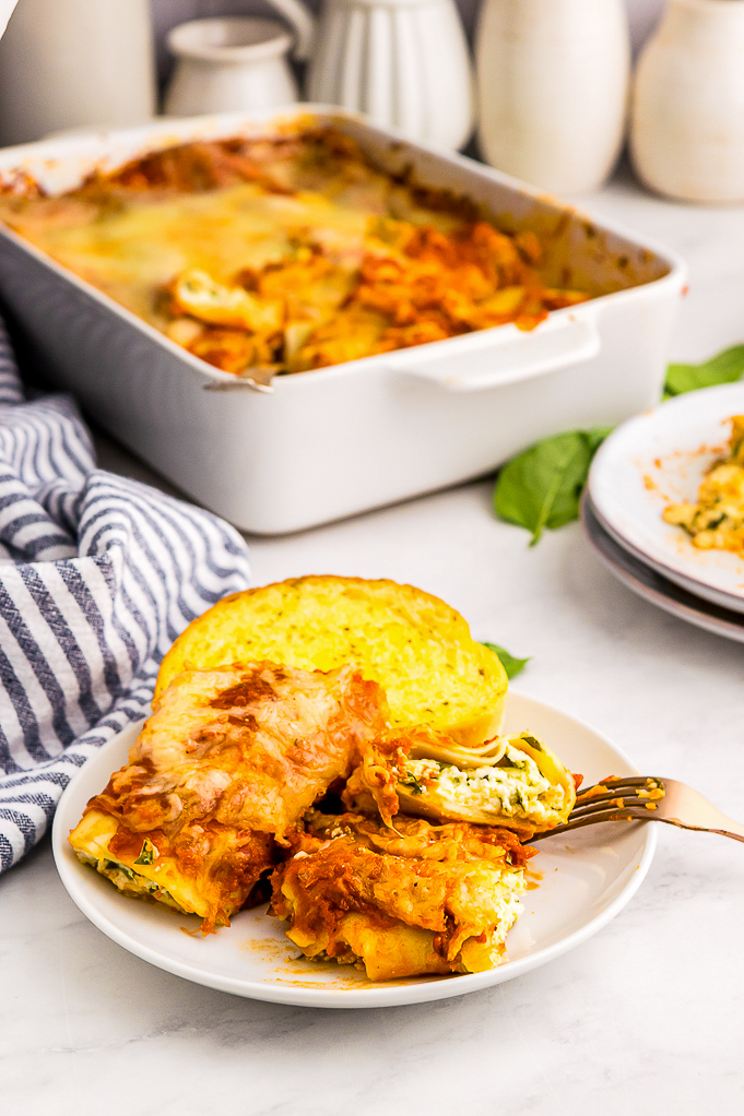 Dinner casserole dish in the background and plate with meal served. 