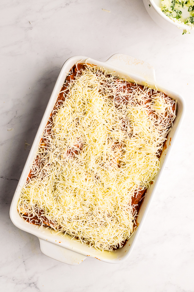 Cheese added to casserole dish before baking.