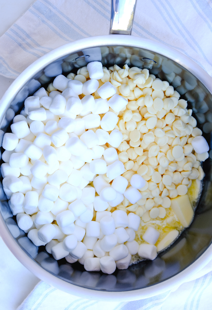 Melting ingredients in a saucepan for white chocolate peppermint fudge.