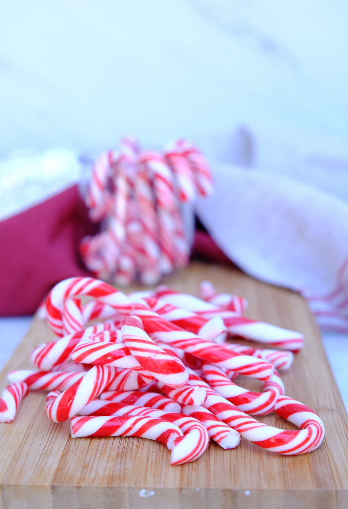 Candy canes on a cutting board.