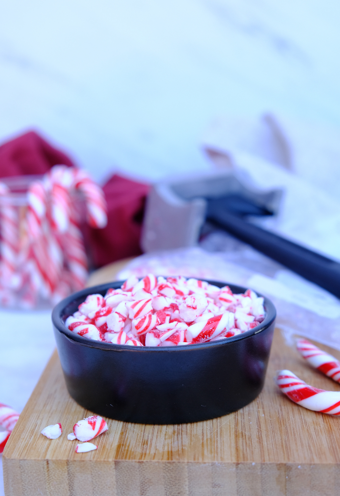 Crushed candy canes in a small black bowl.