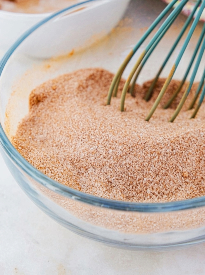 cinnamon sugar mix in a small clear bowl with a whisk.