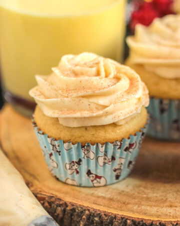 Eggnog cupcakes with buttercream frosting and a sprinkle of cinnamon.