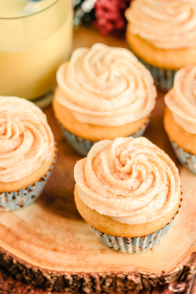 Frosted cupcakes on a wooden pedestal.