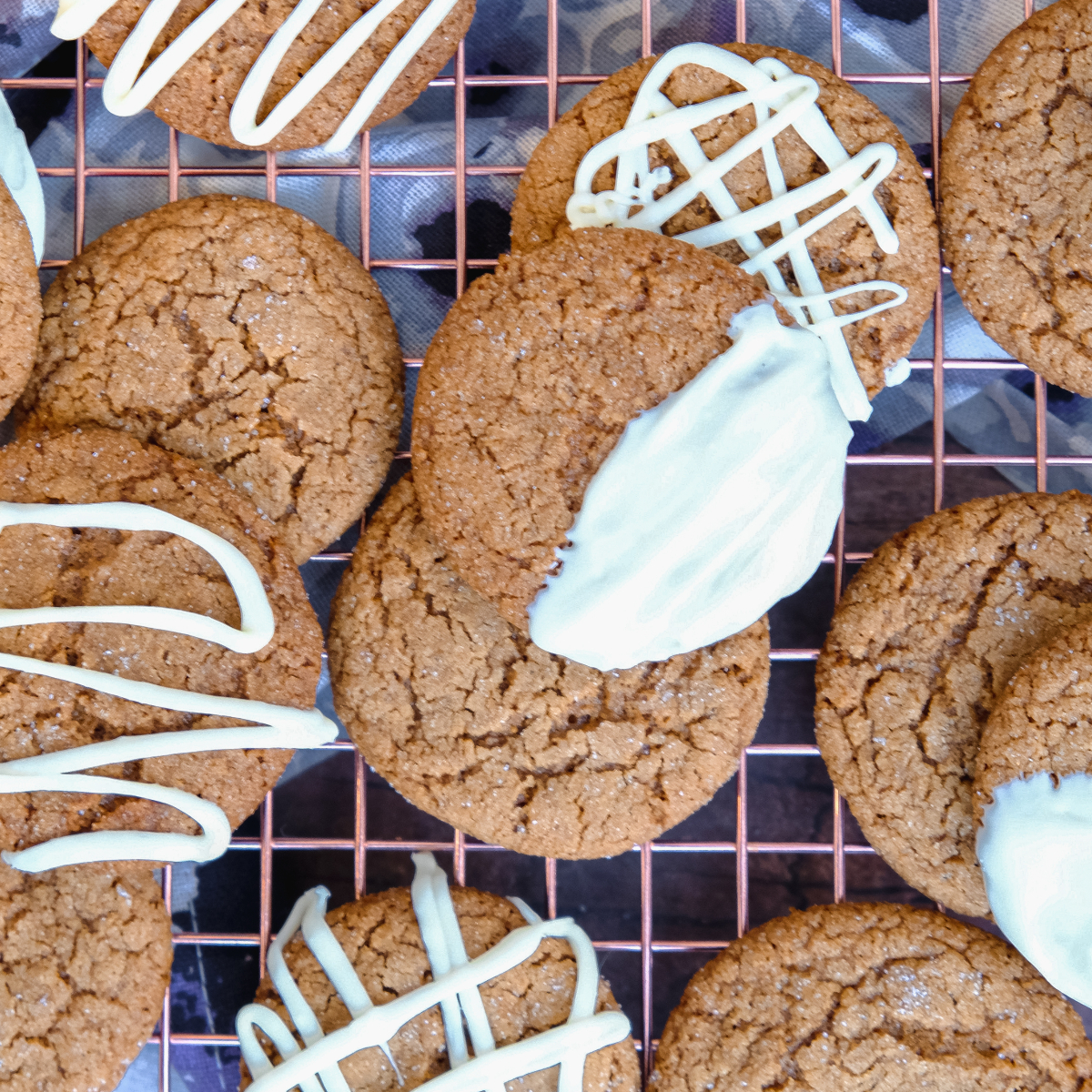 Crispy gingerbread cookies on a cooling rack.
