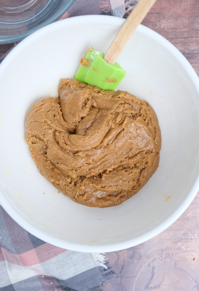 Dough for crispy gingersnap cookie recipe in a white mixing bowl.