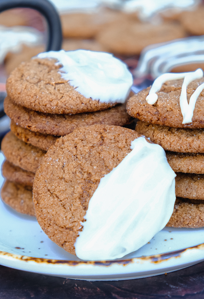 Gingersnap cookies dipped in white chocolate on a cookie platter.