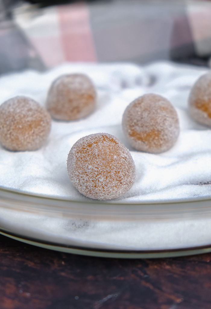 Gingersnap cookies rolled in granulated sugar before baking. 