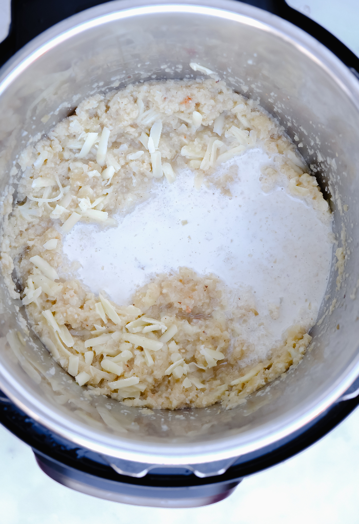 Cream and cheese added to pureed cauliflower for soup recipe.