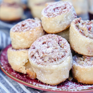 Pecan pie crust cookies on a maroon plate ready to eat.