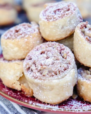 Pecan pie crust cookies on a maroon plate ready to eat.