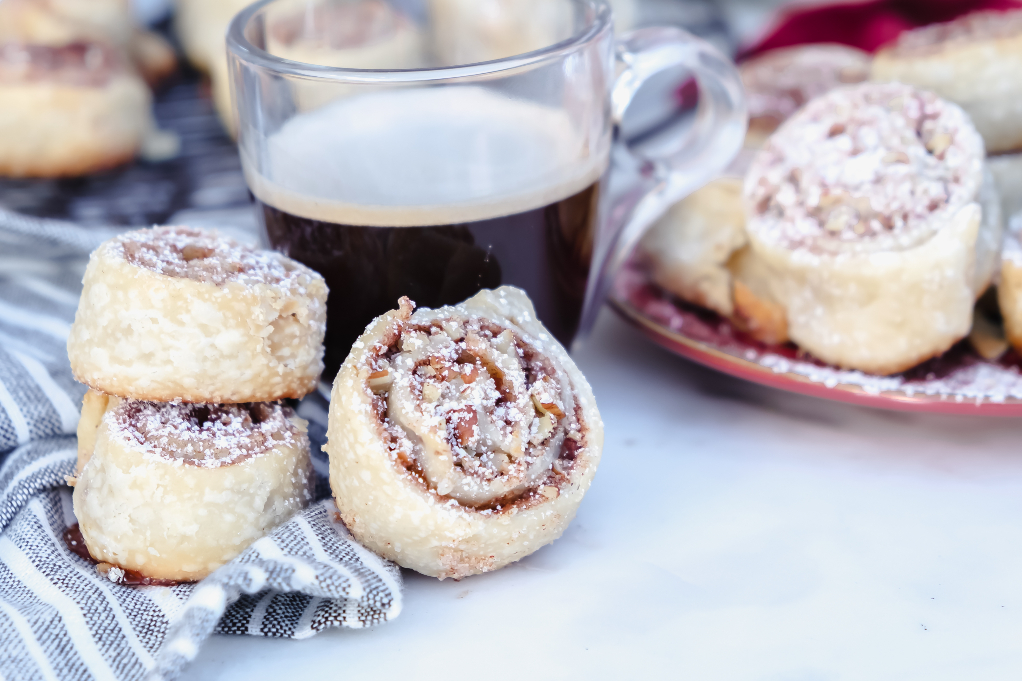 Fresh baked cookies on a plate with a cup of coffee.