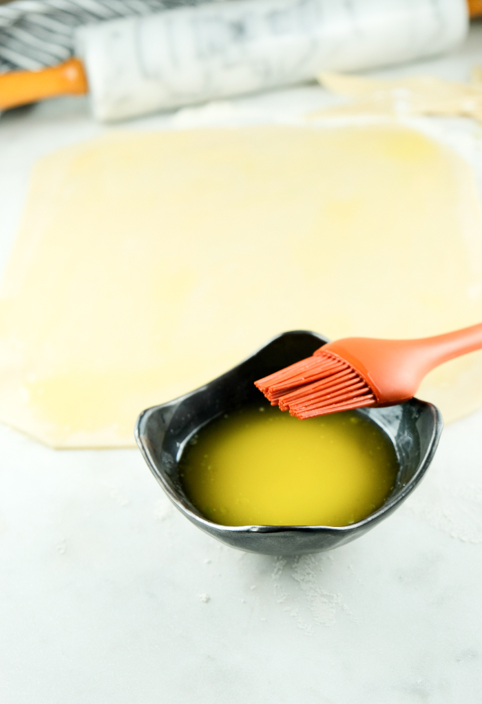 Melted butter in a small bowl ready to coat cookie dough before baking.