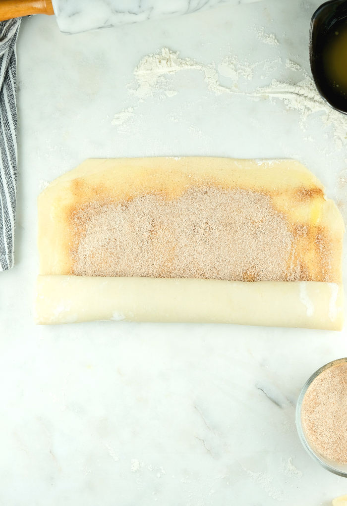 Pie crust dough roll with cinnamon sugar mix.