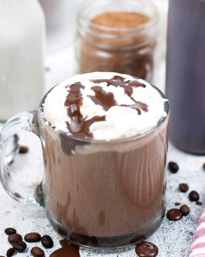 Copycat Starbucks skinny mocha espresso beverage topped with whipped cream and a drizzle of chocolate.