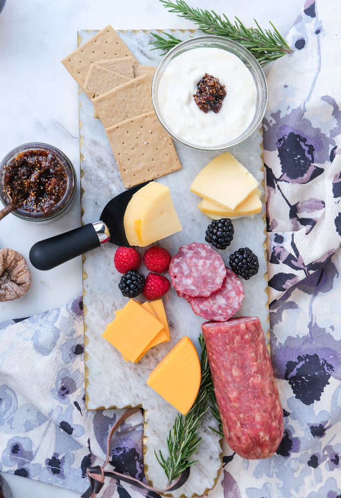 Top view of a cheese platter with chutney on the side. 