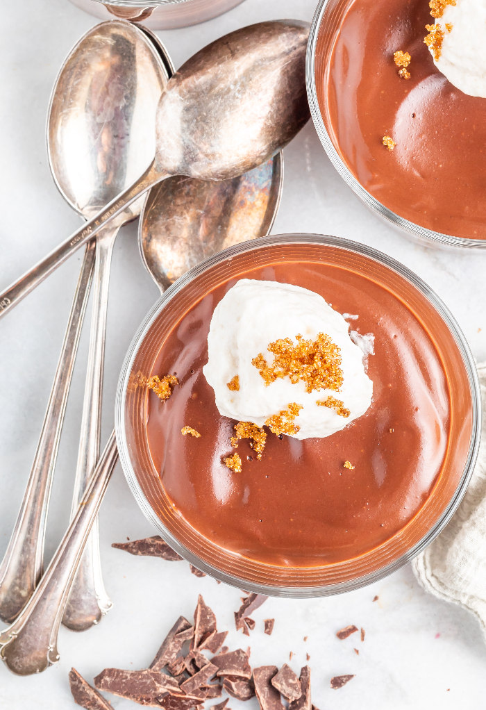 Top view of chocolate pudding topped with whipped cream.