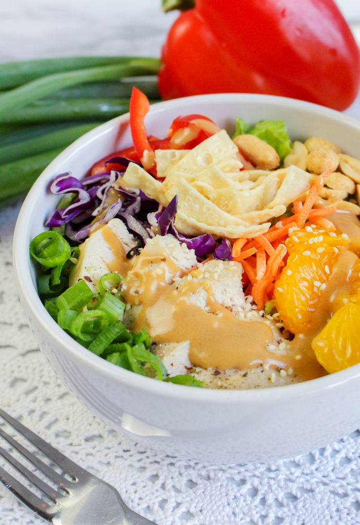 Chinese chicken salad in a white bowl ready to eat. 