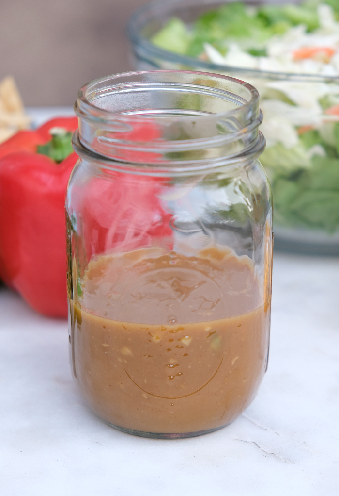 Peanut salad dressing in a mason jar.