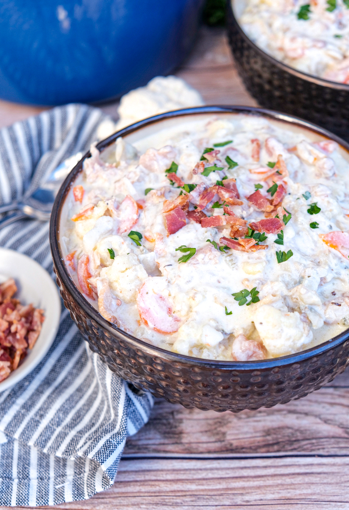 Low carb keto clam chowder topped with bacon and parsley ready to eat. 