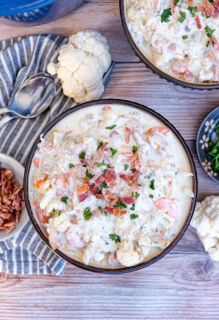 Clam chowder made with cauliflower in serving bowls .