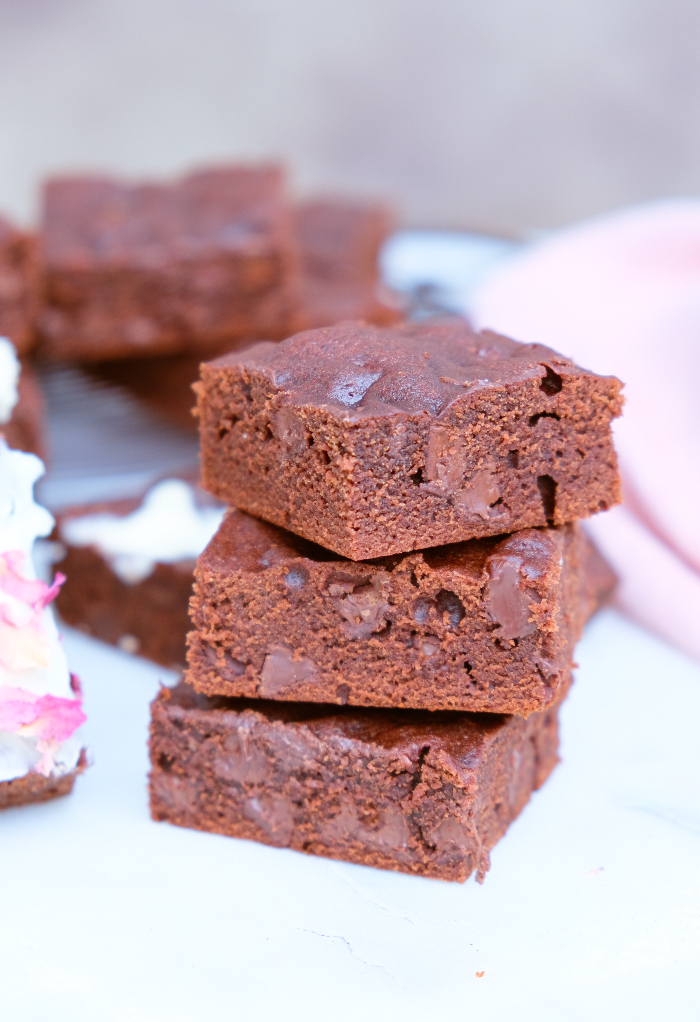 A stack of three brownies. 