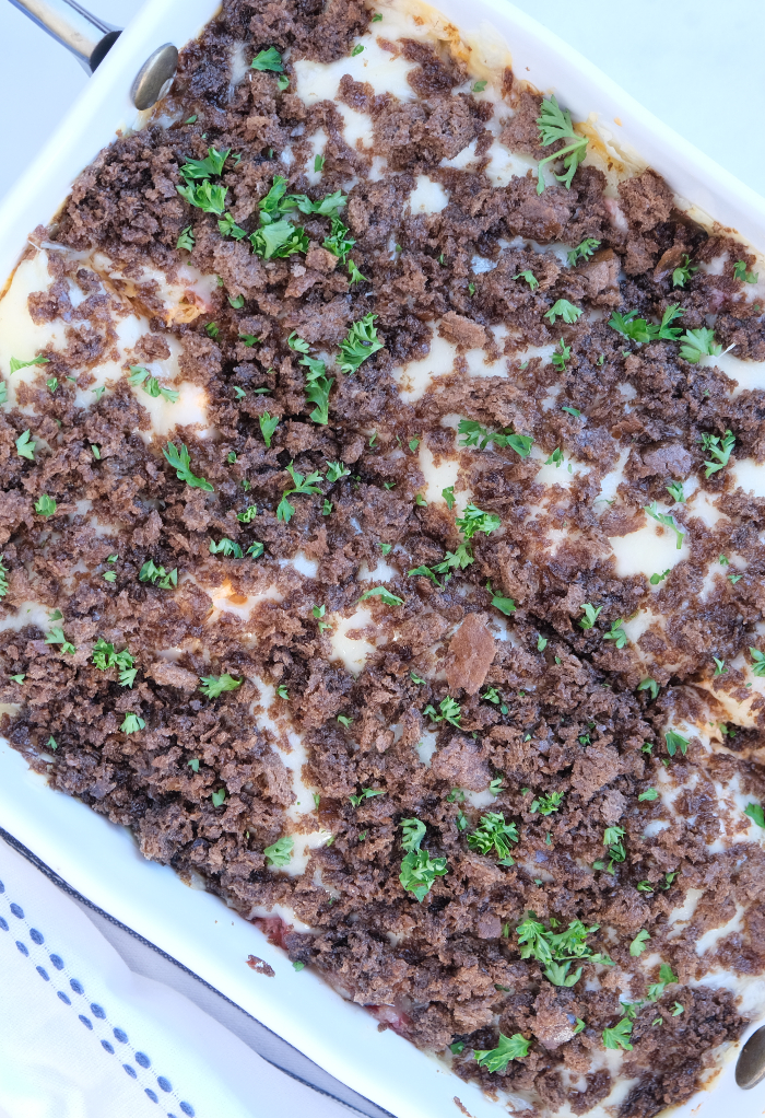 Baked casserole topped with fresh chopped parsley.