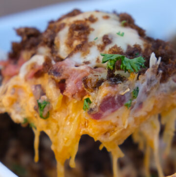 A slice of reuben casserole right out of the casserole dish ready to place on a plate.