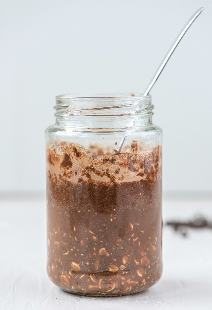 Refrigerated chocolate overnight oats in a mason jar.