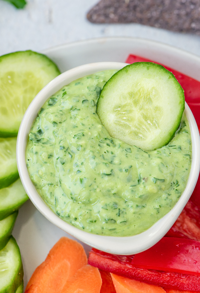 Top view of green goddess dressing used as a vegetable dip. 