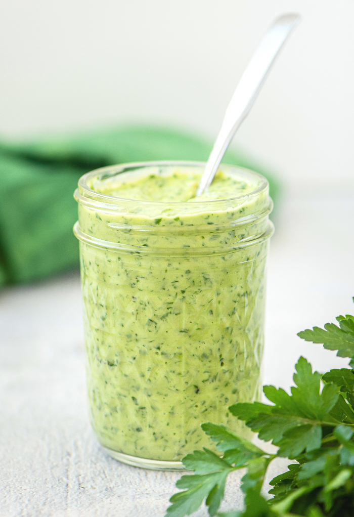 Green goddess dressing in a clear mason jar.