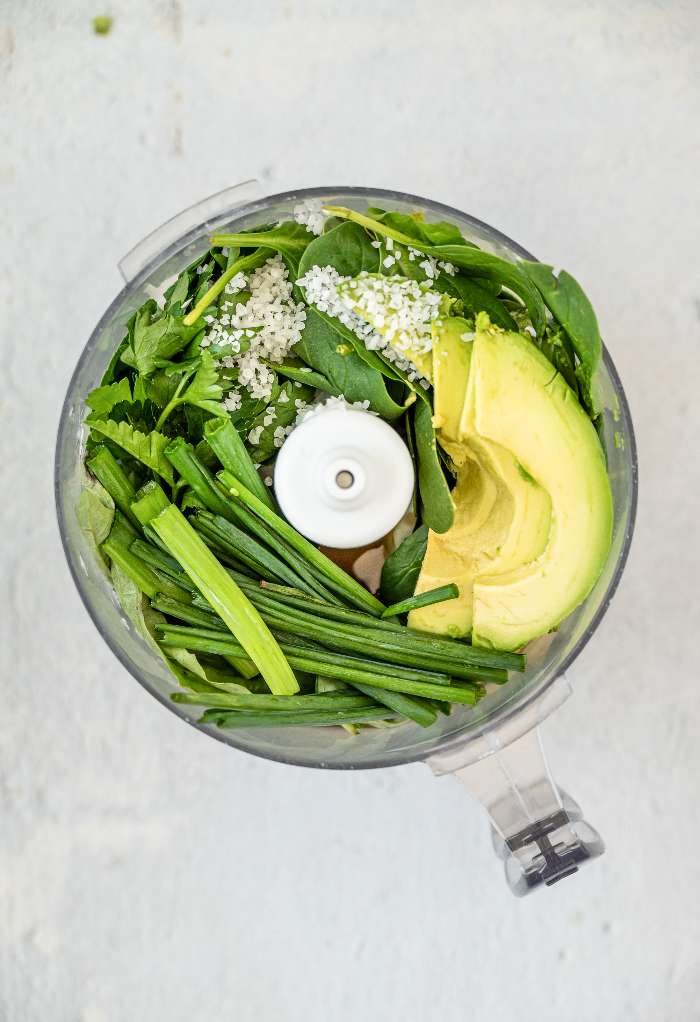 Ingredients in a food processor before blending into a salad dressing.