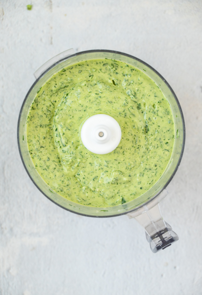 Blended salad dressing ingredients in a food processor. 